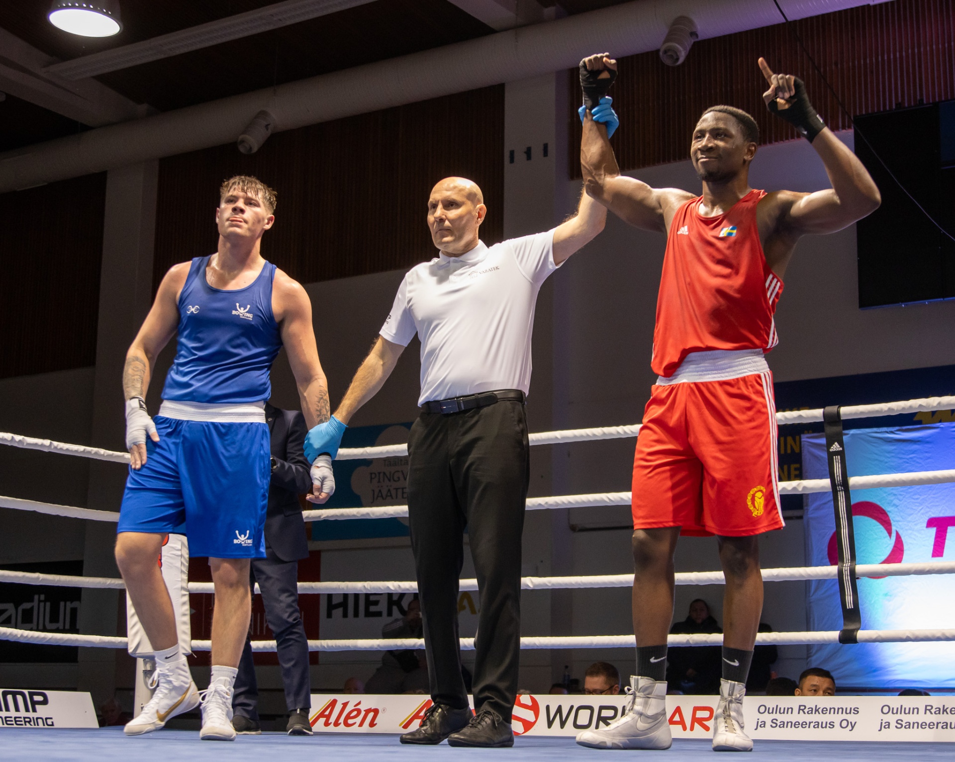 Elwin Belezika having his hand raised in victory